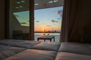 a bedroom with a bed with a view of the ocean at Petras Resort in Falasarna