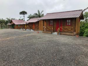 una fila di cabine in legno con vialetto di ghiaia di CASA DI PECORA - POUSADA RURAL a Lauro Müller
