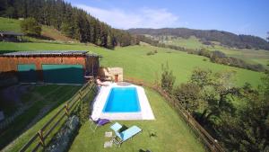 an overhead view of a swimming pool next to a house at Ferienwohnung Dürnberger in Liebenfels