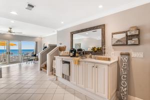 a kitchen with a counter and a mirror at Big O Beach - White Sands Townhomes in Pensacola Beach