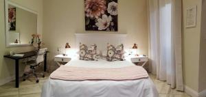 a bedroom with a large white bed with pillows at Andante Lodge in Pretoria