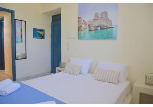 A bed or beds in a room at Tsakonas Plakes Studios