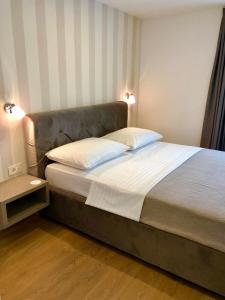 een slaapkamer met een groot bed met 2 kussens bij Casa Rovigno in Rovinj