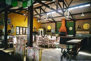 a dining room with a table and some chairs at Espaço Vila Lara in São Roque
