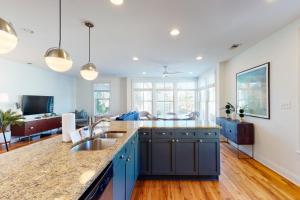 a kitchen with a sink and a living room at Contemporary Home in Perfect Location - 207 B St Philip Street in Charleston