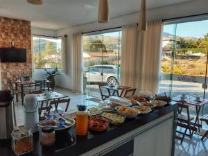 a buffet of food on a counter in a room at POUSADA LIMAS SUITES in Capitólio