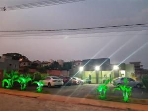 a view through a window of a parking lot at night at POUSADA LIMAS SUITES in Capitólio