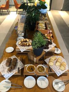 a table topped with lots of different types of food at Slaviero Campina Grande in Campina Grande