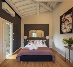 a bedroom with a large bed with a large mirror at Podere GIUSTI in Reggello