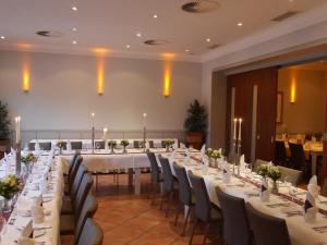 a large banquet hall with white tables and chairs at Hotel-Restaurant Große-Wilde in Bottrop