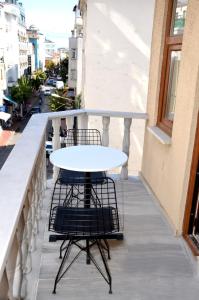 a white table and chairs on a balcony at Sultanahmet çoşkun hotel in Istanbul