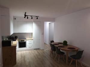 a kitchen and dining room with a table and chairs at Apartament Marcella in Gorzów Wielkopolski +11 photos