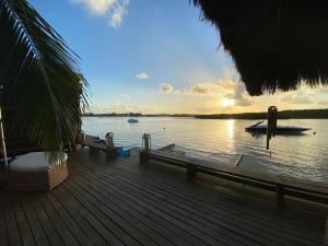 a wooden deck with a view of the water at Casa praia Porto de Galinhas Toquinho in Ipojuca