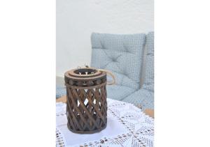 a rattan basket sitting on a table with a chair at Tsakonas Plakes Studios in Plaka Milou