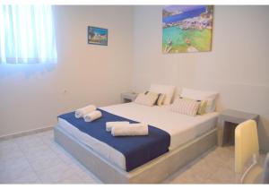 A bed or beds in a room at Tsakonas Plakes Studios