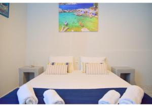 A bed or beds in a room at Tsakonas Plakes Studios