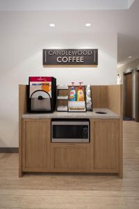 a counter with a microwave on top of it at Candlewood Suites - San Antonio - Schertz, an IHG Hotel in Schertz