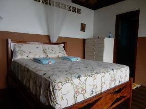 a bedroom with a bed with two pillows on it at Pousada Mar de Sonhos in Praia de Araçatiba
