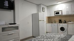 a kitchen with a refrigerator and a washer and dryer at virginia-48 in Benidorm