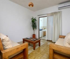 a living room with two beds and a table at Emperador Vallarta Beachfront Hotel and Suites in Puerto Vallarta