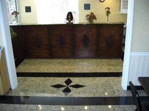 a woman sitting at a counter in a room at Travelers Inn & Suites in Sumter