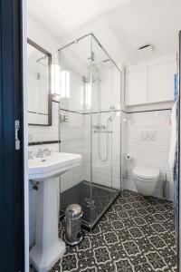 un bagno con doccia, lavandino e WC di Résidence du Louvre a Parigi