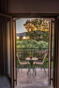 a patio with a table and chairs on a balcony at Castelli Hotel-Adults Only in Laganas