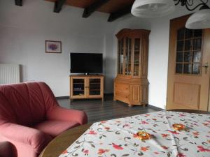 ein Wohnzimmer mit einem Sofa, einem TV und einem Tisch in der Unterkunft sonja in Ditzum