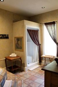 a living room with a large window and a table at Norfolk Guest House Inn in Guelph