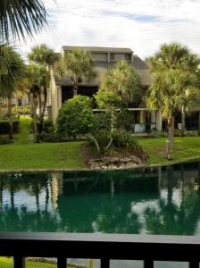 a house with a swimming pool in front of a house at Island Life in Saint Augustine Beach