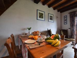 a wooden table with a bunch of fruit on it at Tranquil Holiday Home in Houffalize with Barbecue in Nadrin