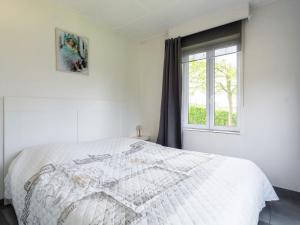 a white bedroom with a bed and a window at Beautiful house with view of the Houille valley in Vencimont