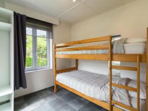 two bunk beds in a room with a window at Beautiful house with view of the Houille valley in Vencimont