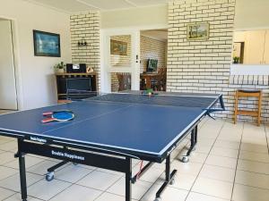 a ping pong table in the middle of a room at Cuddles Cottage 4 Christmas Bush Avenue - holiday house near Dutchies in Nelson Bay