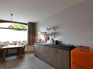 a kitchen with an orange refrigerator and a table at Studio in Ieper with terrace in Ieper