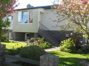 a house with stairs and flowers in a yard at Wonderful Apartment in Elpe with Garden in Kröpelin