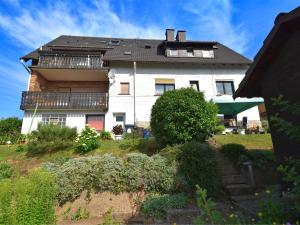 a large white house on top of a hill at Quaint Apartment in Gro almerode near the Forest in Großalmerode