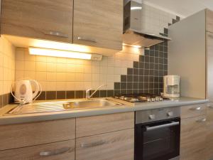 a kitchen with a sink and a stove at Apartment in Zell near Mosel River & Vineyards in Zell an der Mosel