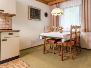 a kitchen and dining room with a table and chairs at Cosy apartment in Bad Rippoldsau with terrace in Bad Rippoldsau