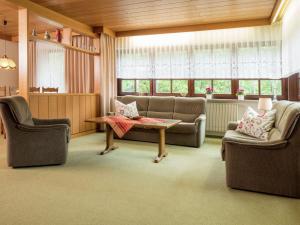 a living room with two chairs and a couch and a table at Cosy apartment in Bad Rippoldsau with terrace in Bad Rippoldsau