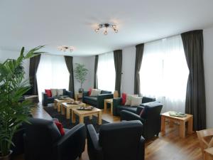 a living room with couches and tables and windows at Garden view Villa in Medebach K stelberg in Medebach