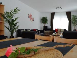 a living room with a table and chairs and a couch at Garden view Villa in Medebach K stelberg in Medebach