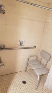 a chair in a bathroom with a towel at Royal Century Hotel at LAX in Inglewood +23 photos
