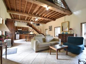 a living room with a couch and a table at Cozy Holiday Home in Lantheuil with Garden in Lantheuil