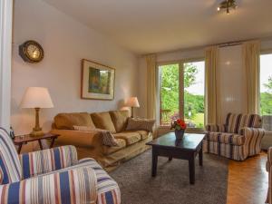 a living room with a couch and a table at Apartment close to the sea in Chavenon