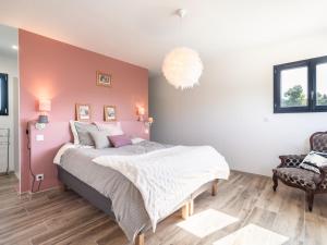 a bedroom with a large bed and a chair at Holiday Home Beaufort with Private Pool in Beaufort +32 photos