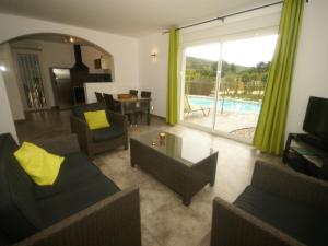 a living room with a couch and chairs and a pool at Charming villa with private pool near the Ard che river in Auriolles