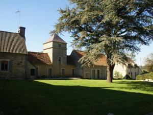 a large house with a tree in the yard at Holiday home with private garden in Wierre Effroy in Rinxent