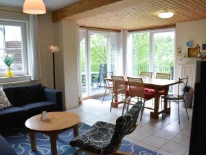 a living room with a table and chairs at Apartment with private garden in the heights of Bouillon in Bouillon