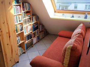 a living room with a couch and some book shelves at Ostsee 1 in Zierow